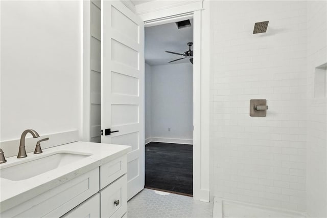 bathroom featuring tile patterned floors, a shower, vanity, and ceiling fan