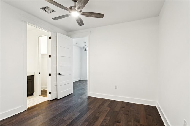 unfurnished bedroom with ensuite bath, ceiling fan, and dark hardwood / wood-style floors