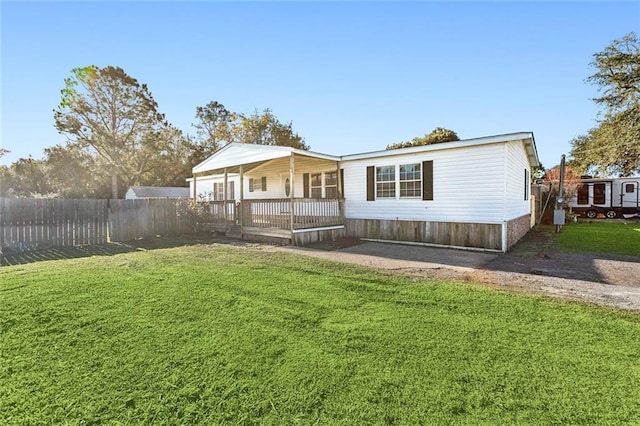 rear view of property with a lawn and covered porch