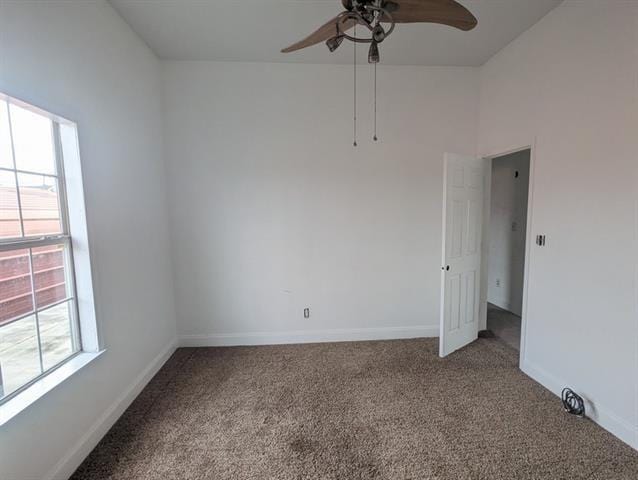 carpeted empty room featuring ceiling fan