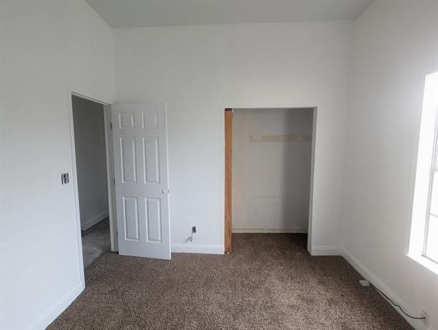 unfurnished bedroom with a closet and carpet