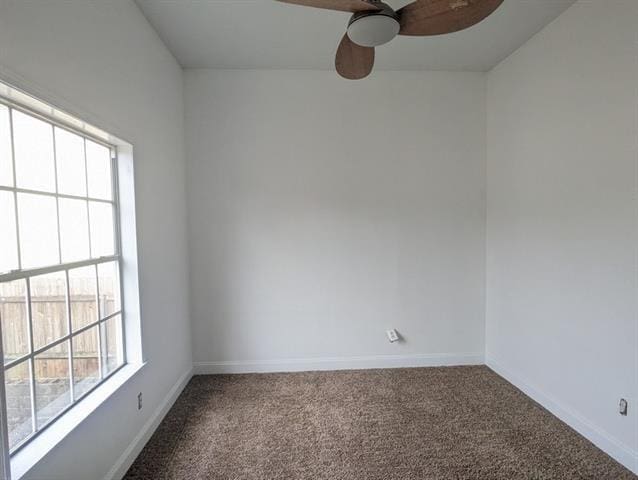 carpeted spare room featuring ceiling fan