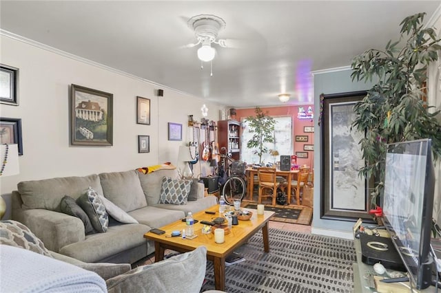 living room with ceiling fan and crown molding