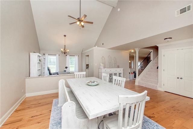 dining room with stairway, visible vents, baseboards, light wood finished floors, and ceiling fan with notable chandelier