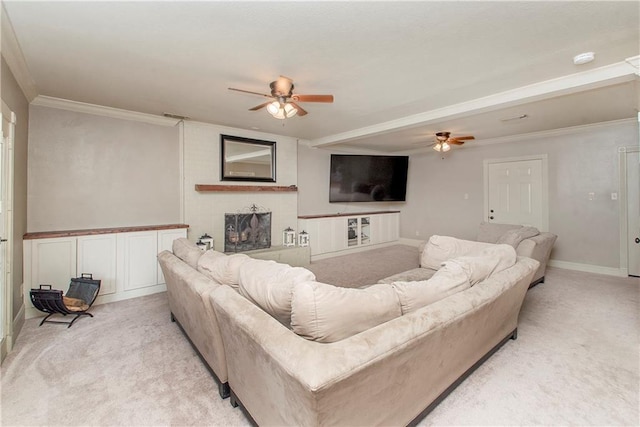 living area featuring light colored carpet, a fireplace, crown molding, and ceiling fan