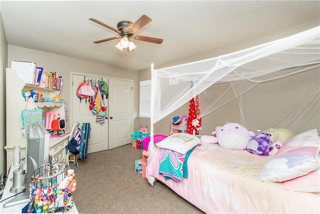 bedroom with carpet, ceiling fan, and a textured ceiling