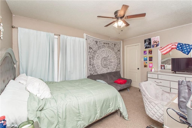 carpeted bedroom featuring a textured ceiling and ceiling fan