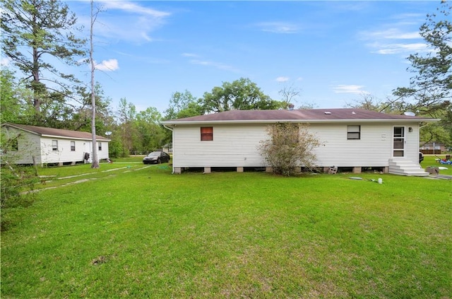 back of house featuring a lawn