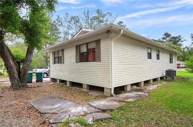 view of property exterior featuring a lawn and central AC unit