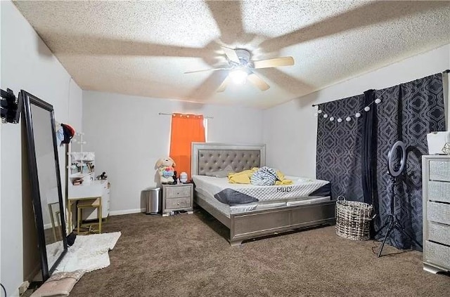 bedroom featuring dark colored carpet, a textured ceiling, and ceiling fan