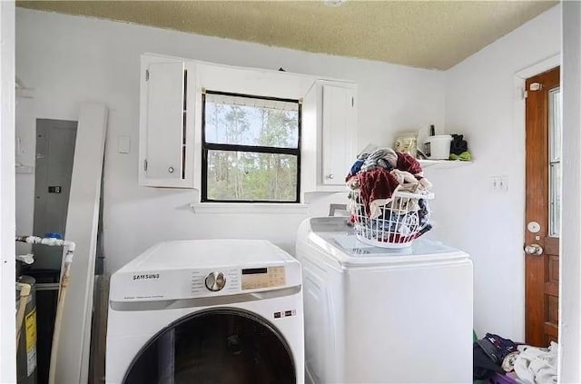 laundry room with washer and dryer and cabinets