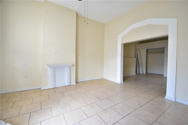 empty room featuring ceiling fan and light tile patterned flooring