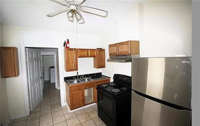 kitchen featuring stainless steel fridge, ceiling fan, sink, black / electric stove, and light tile patterned flooring