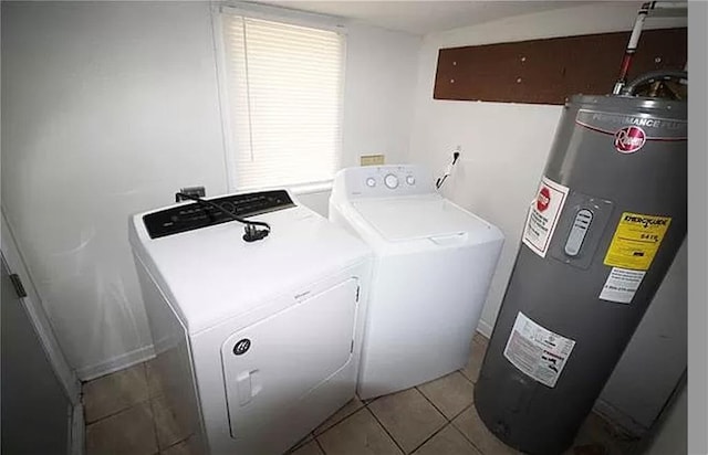 laundry room with light tile patterned flooring, electric water heater, and washing machine and clothes dryer