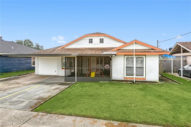 view of front of property featuring brick siding, concrete driveway, and a front lawn