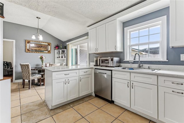 kitchen with a sink, a peninsula, white cabinets, light countertops, and dishwasher