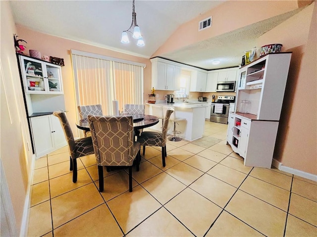 dining area featuring light tile patterned floors, baseboards, visible vents, lofted ceiling, and a notable chandelier