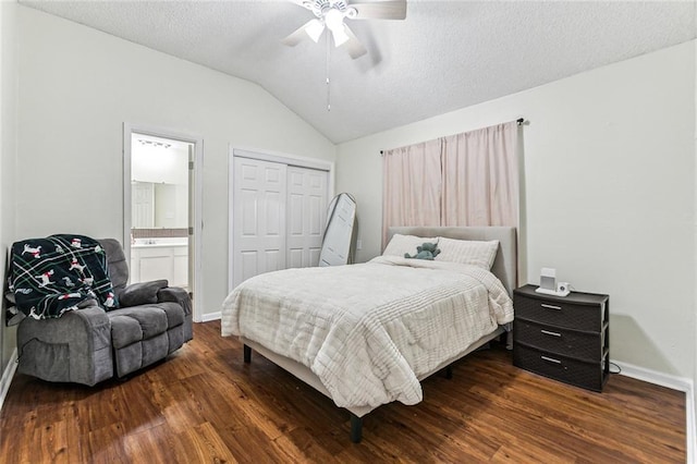 bedroom featuring lofted ceiling, wood finished floors, a closet, and a textured ceiling