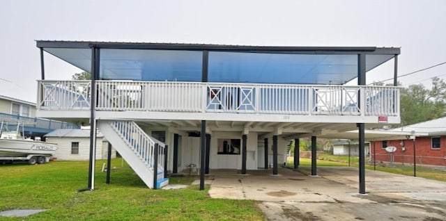 108 Pellegrin St, Chauvin, LA 70344 - back of house featuring a carport and a lawn