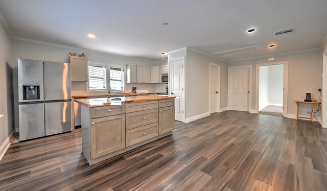 108 Pellegrin St, Chauvin, LA 70344 - kitchen featuring dark hardwood / wood-style flooring, a center island, ornamental molding, and appliances with stainless steel finishes