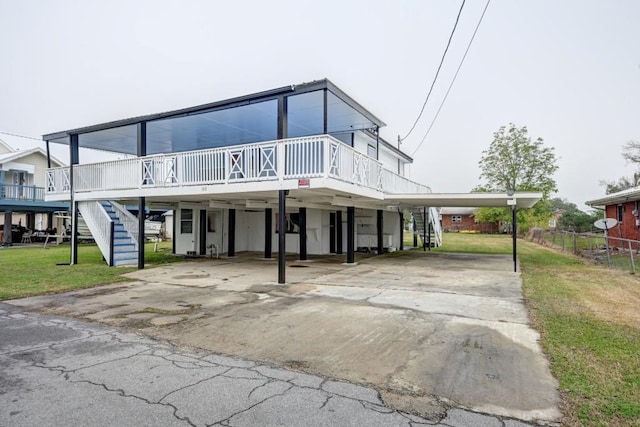 108 Pellegrin St, Chauvin, LA 70344 - view of front facade featuring a front yard and a carport