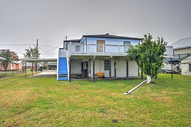 108 Pellegrin St, Chauvin, LA 70344 - back of property with a yard, a deck, and a carport