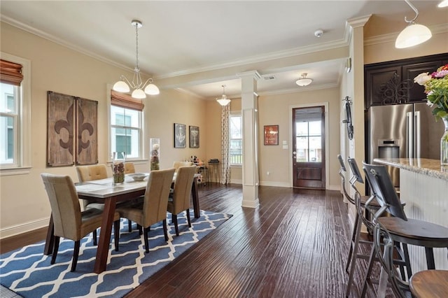 dining room with a notable chandelier, plenty of natural light, ornate columns, and ornamental molding