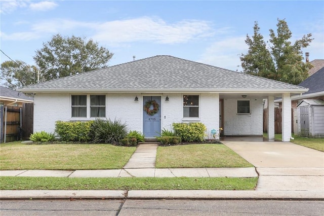 single story home featuring a carport and a front lawn