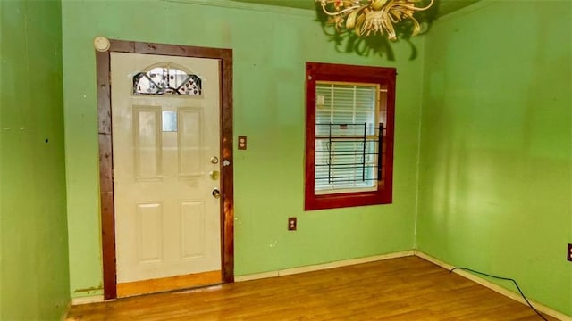 entryway with a notable chandelier and wood-type flooring