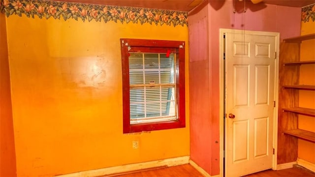 1409 Delery St, New Orleans, LA 70117 - unfurnished bedroom with wood finished floors and baseboards