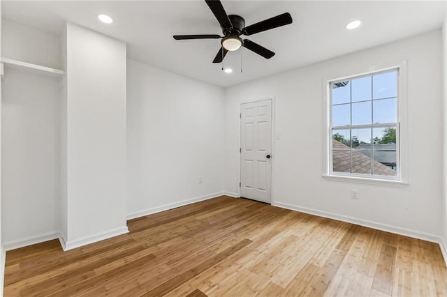 unfurnished room with ceiling fan and light hardwood / wood-style floors