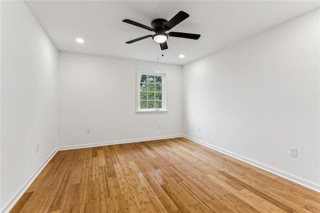 spare room featuring light hardwood / wood-style floors and ceiling fan