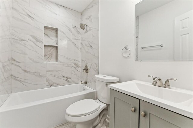 full bathroom featuring vanity, toilet, and tiled shower / bath