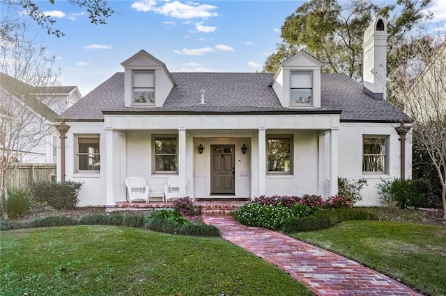 view of front of house with covered porch and a front yard