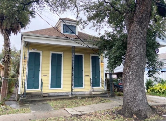 view of front of property featuring entry steps and a shingled roof