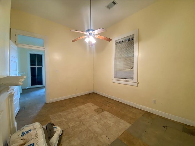 unfurnished room featuring a ceiling fan, visible vents, and baseboards