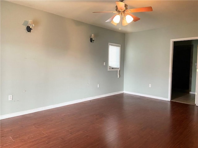 unfurnished room with dark wood-style floors, ceiling fan, and baseboards