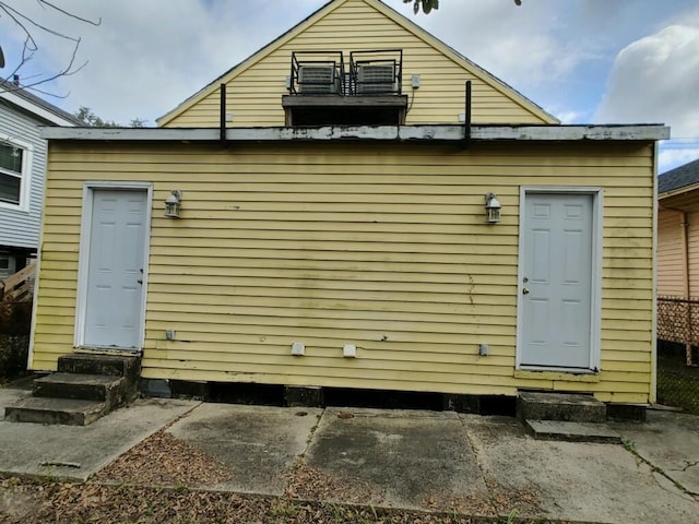 rear view of house featuring entry steps