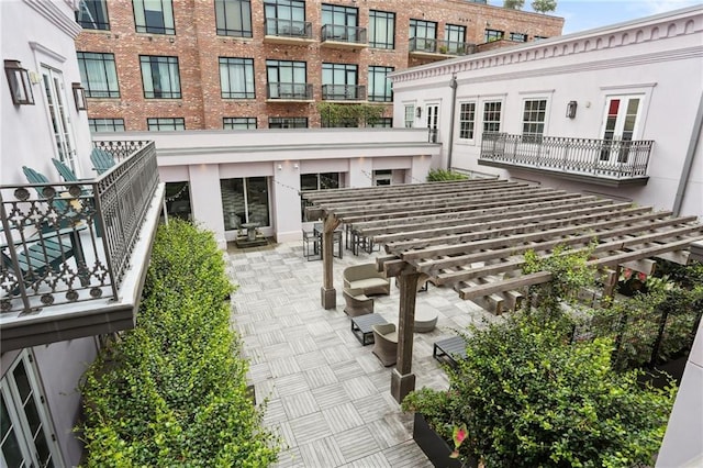 view of property's community featuring a pergola and a patio area