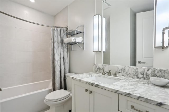 full bathroom with shower / bath combination with curtain, vanity, and toilet