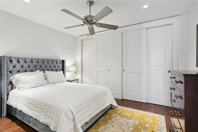 bedroom with dark hardwood / wood-style floors and ceiling fan