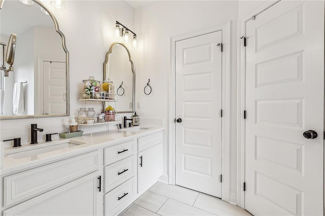 full bathroom with double vanity, a sink, and tile patterned floors