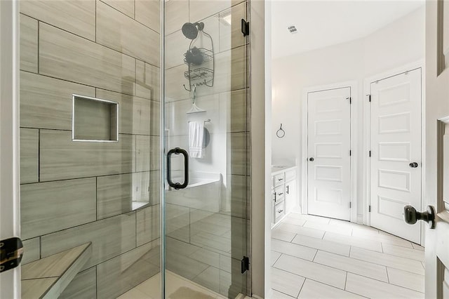 full bathroom with a stall shower and visible vents