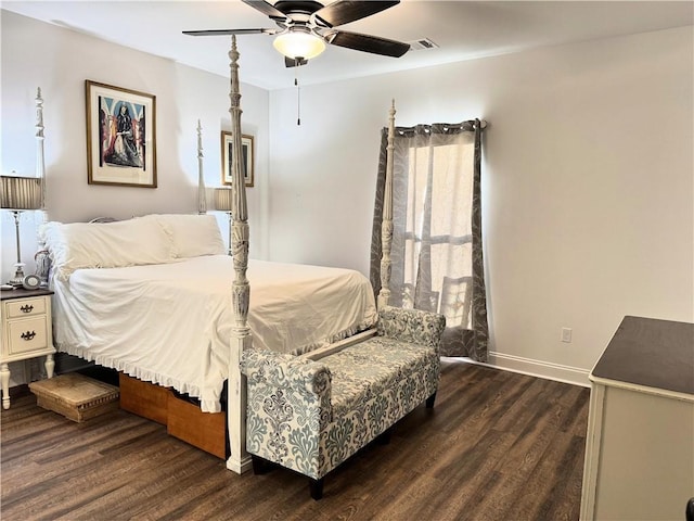 bedroom with a ceiling fan, visible vents, baseboards, and wood finished floors