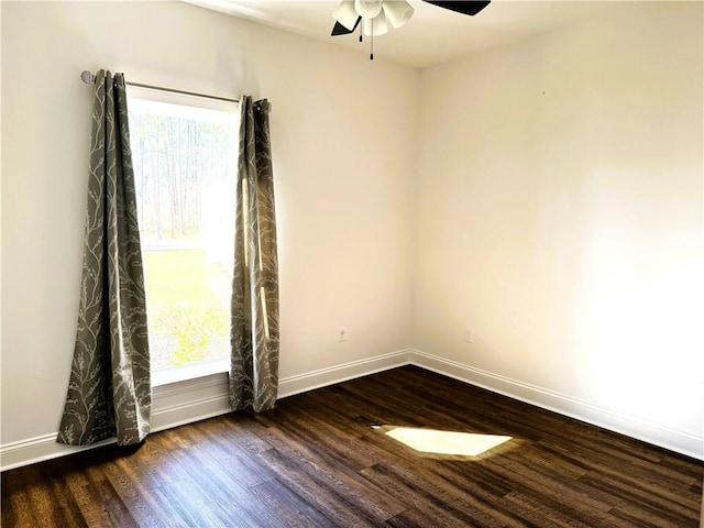 spare room with ceiling fan, wood finished floors, and baseboards