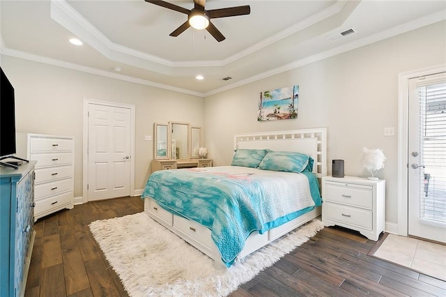 bedroom with a raised ceiling, crown molding, ceiling fan, and dark hardwood / wood-style flooring