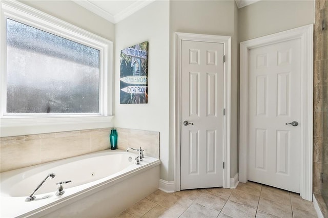 bathroom featuring ornamental molding, tile patterned floors, and a bathing tub