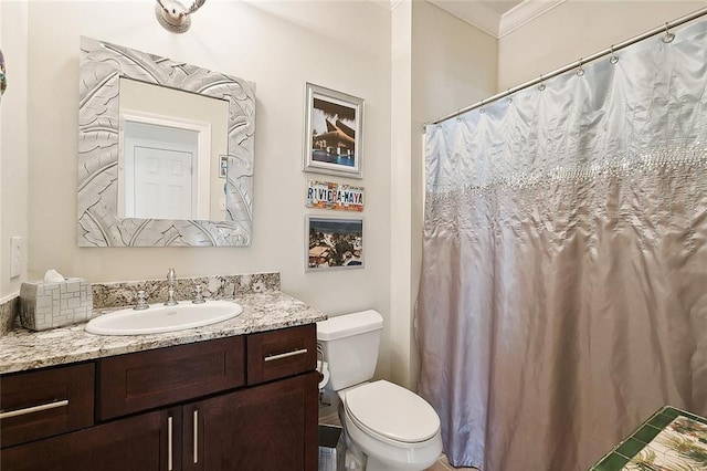 bathroom featuring vanity, ornamental molding, and toilet