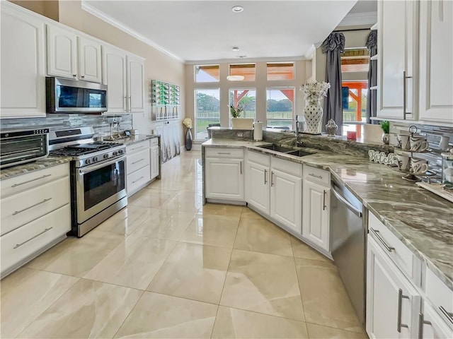 kitchen featuring stone counters, white cabinetry, sink, and appliances with stainless steel finishes