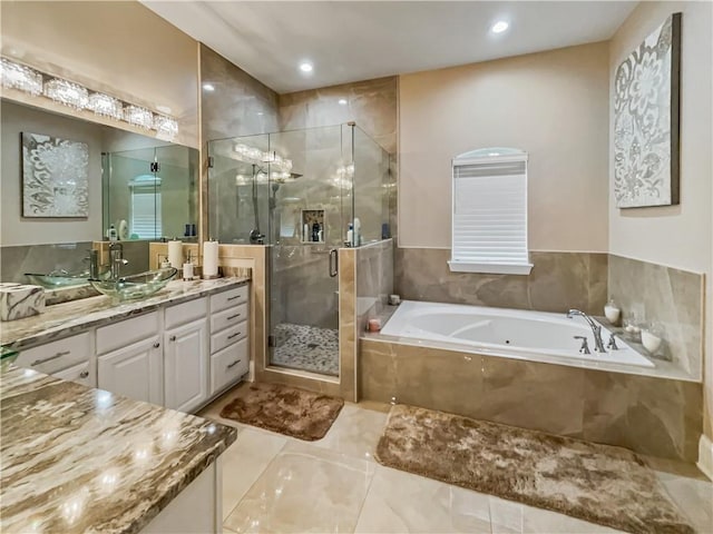 bathroom featuring vanity and independent shower and bath